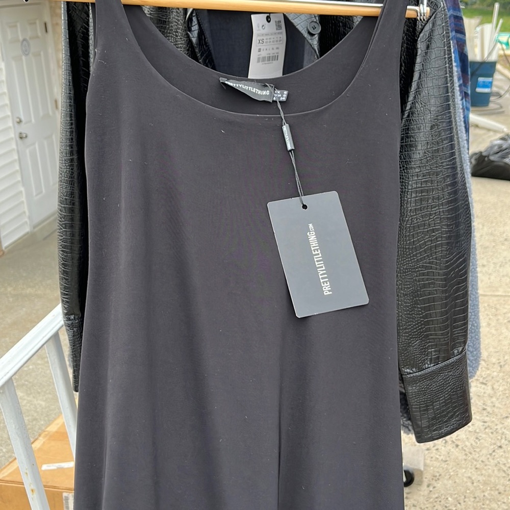 Black slinky midi dress. Pretty little thing. New with tags. Size 2.